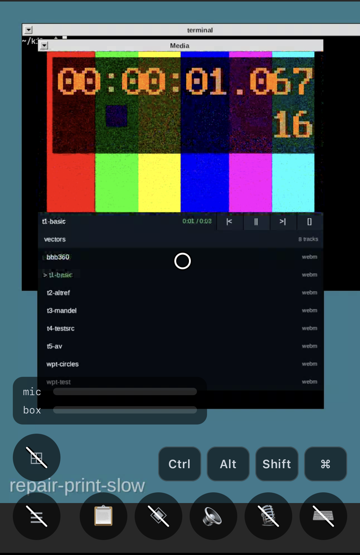 A phone screen showing the glass desktop through the browser: a Media window playing a WebM test vector with a timecode overlay reading 00:00:01.067 over colour bars, a track list of eight WebM files, mic and box level meters, and a row of Ctrl, Alt, Shift and Command keys.